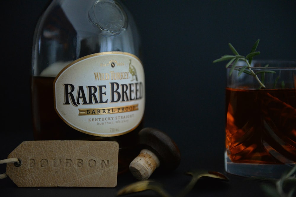 a bottle of alcohol next to a glass of alcohol