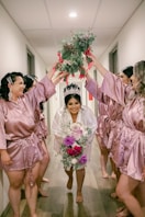 a group of people in pink suits