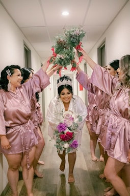 a group of people in pink suits