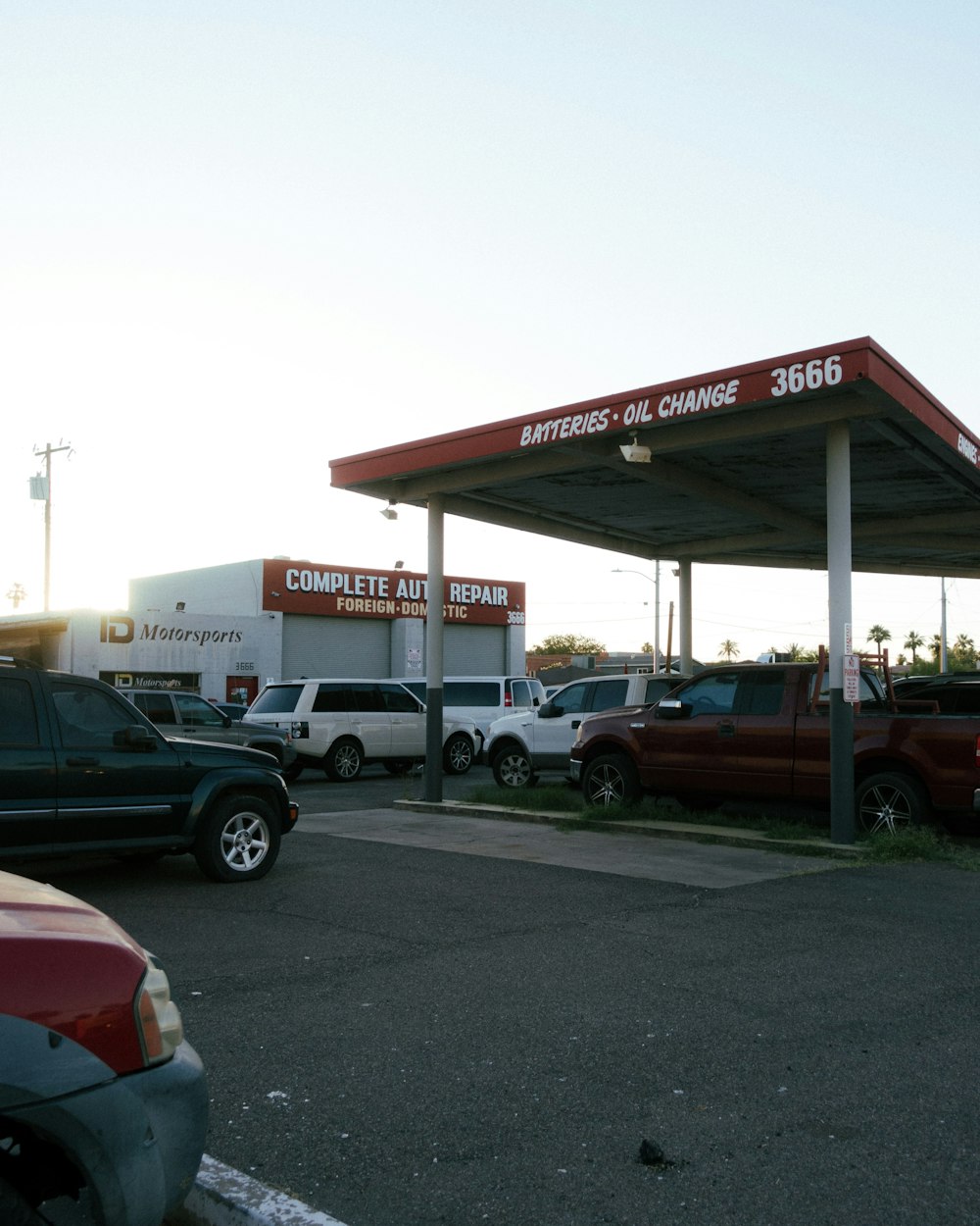 a gas station with cars parked in front of it