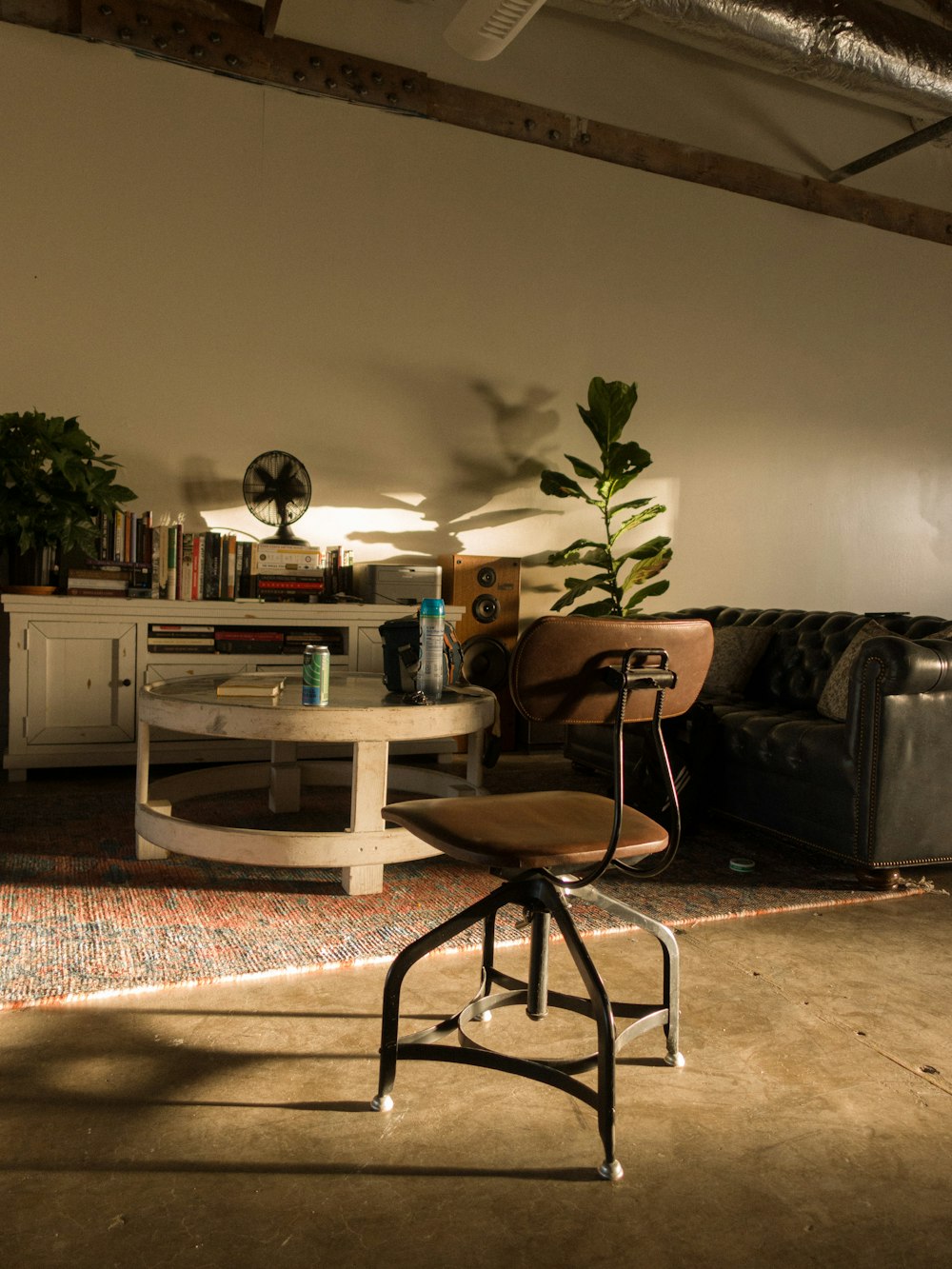 a chair and a table in a room with a plant on the table