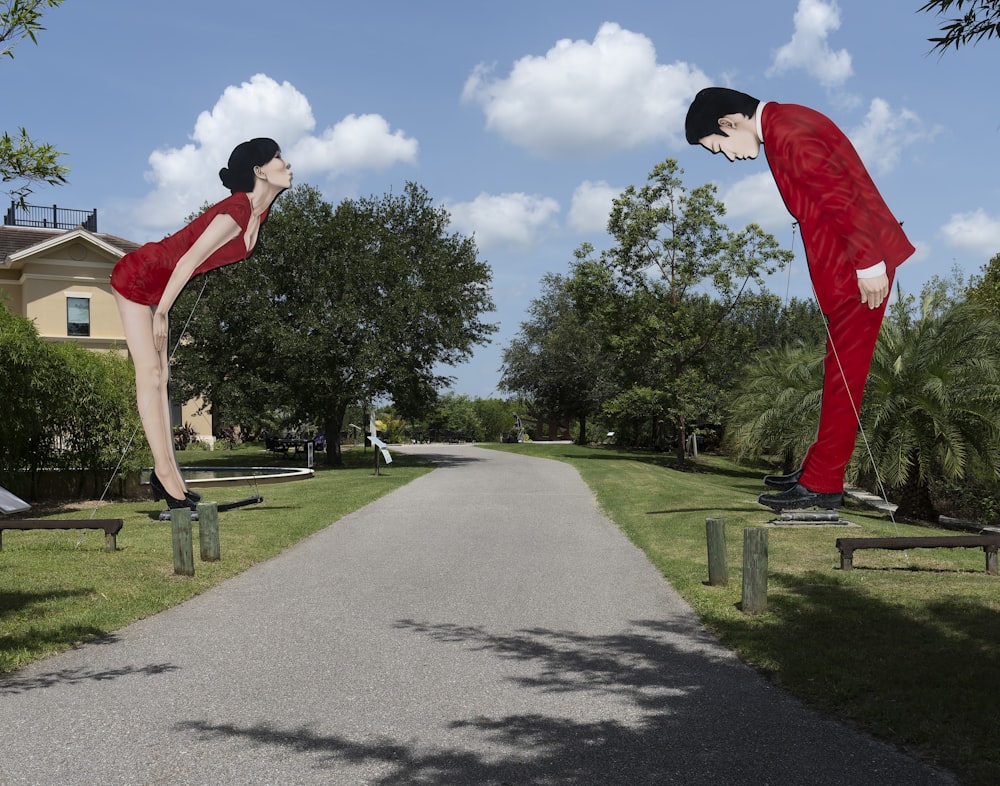 a couple of people in clothing walking down a sidewalk