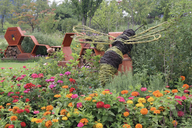 a garden with flowers and a statue