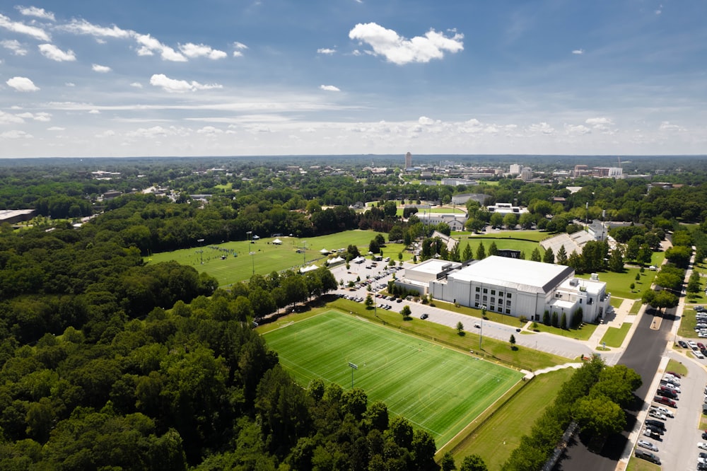 a large green landscape with buildings and trees