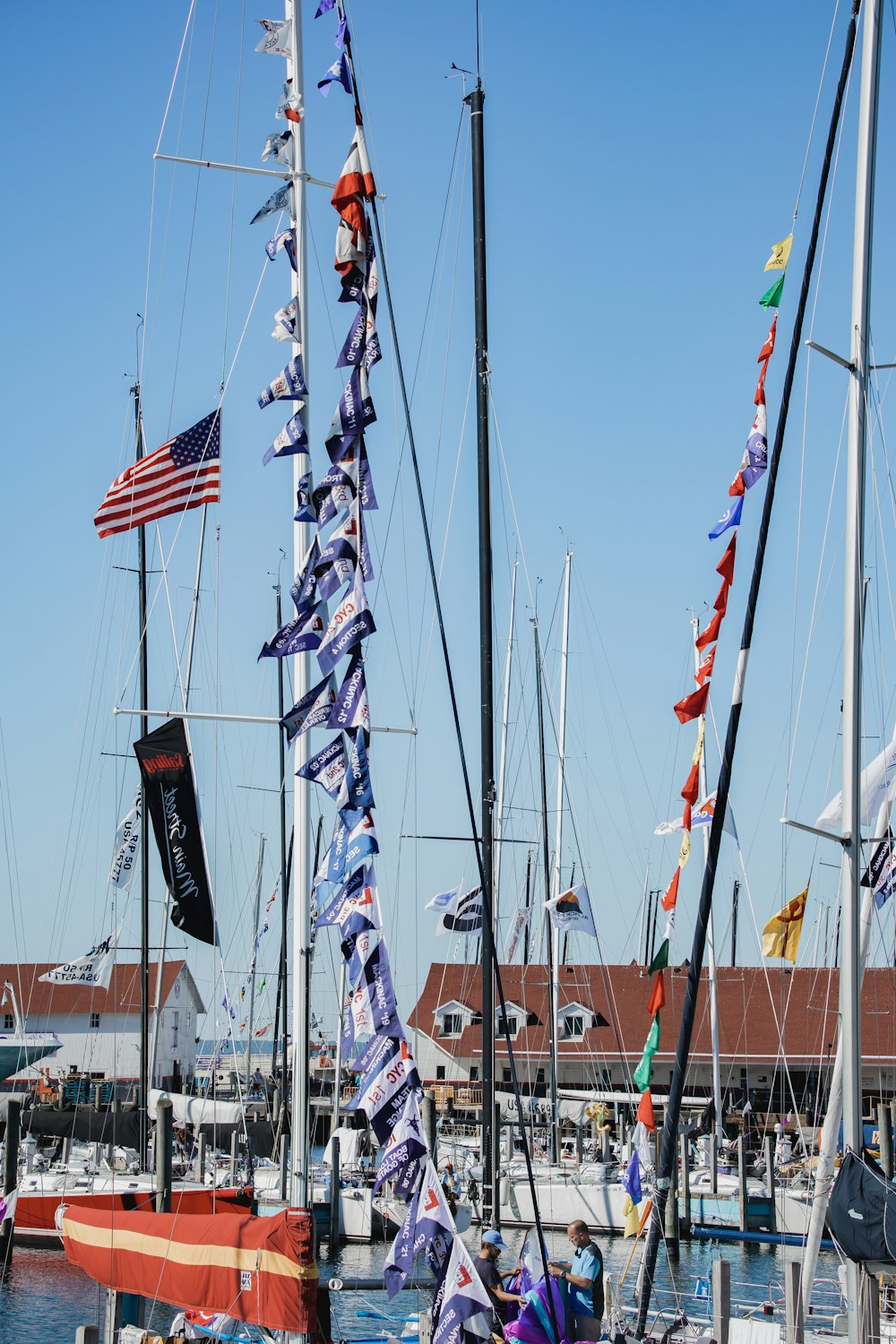 a group of sailboats with flags