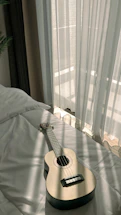 A warm, inviting Martin guitar resting against a wooden pew bathed in soft morning light