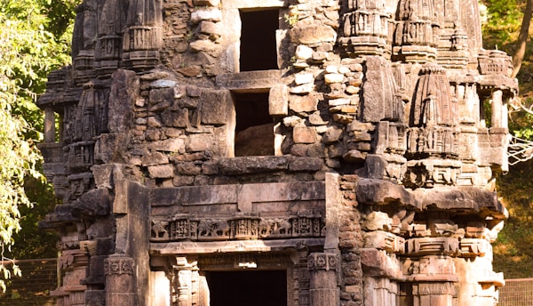 A vibrant close-up of an ancient Indian temple carving bathed in warm sunlight.
