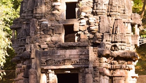 Ancient stone carvings at a historic temple bathed in golden sunlight.