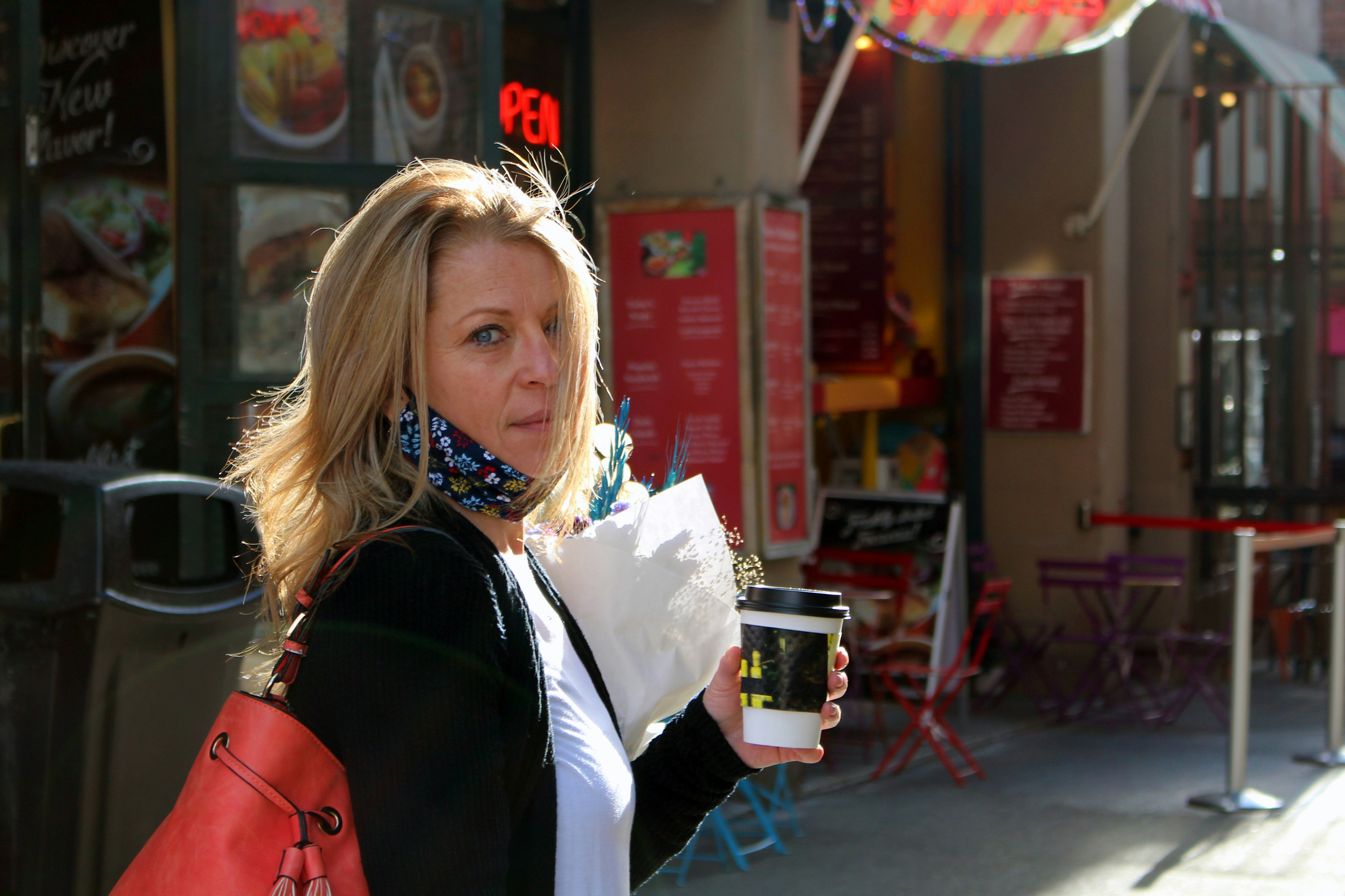 A woman holding a drink and looking at the camera photo – Free Seattle ...