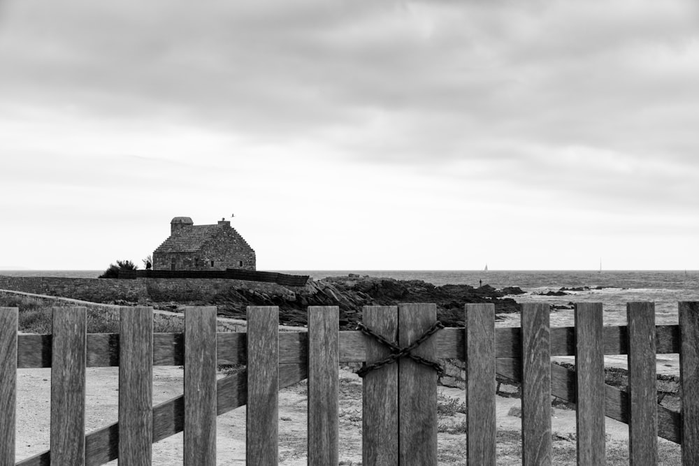 a stone building behind a fence