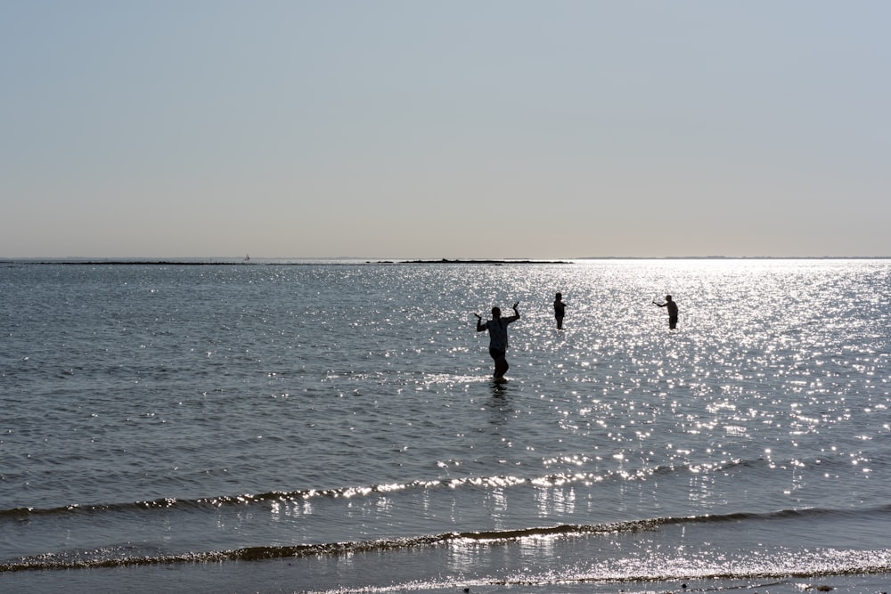 a group of people standing in the water