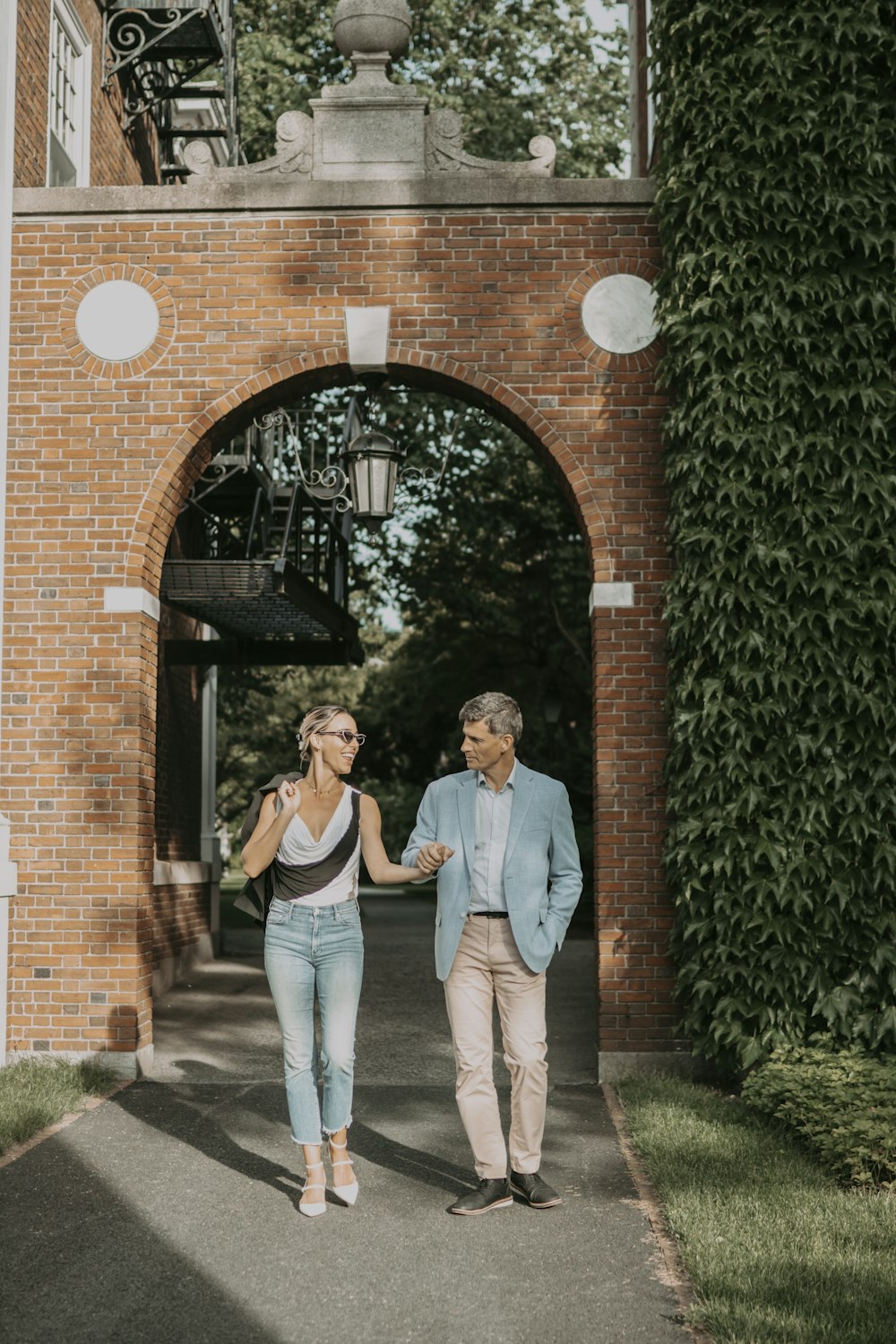 a man and woman walking down a sidewalk