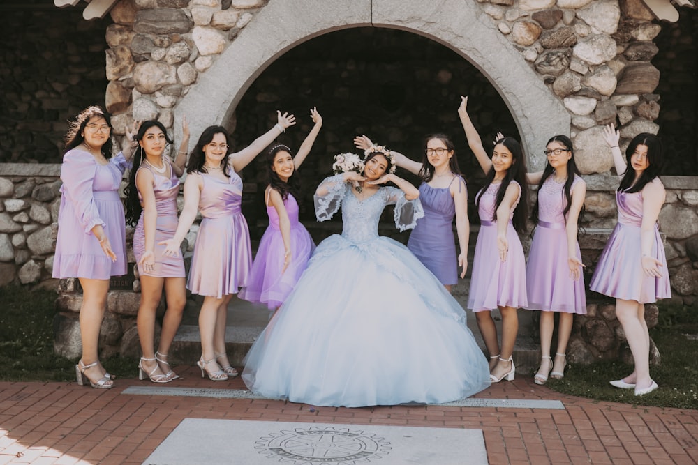 a group of women in dresses posing for a photo