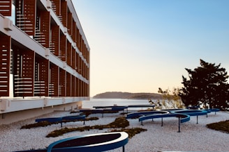 A modern marble building with a view of the Aegean Sea.