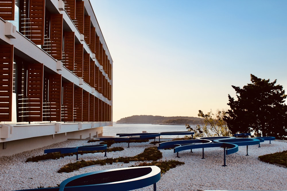 a building with a pool and tables outside