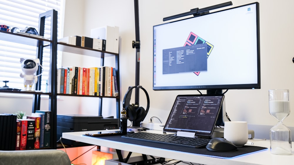 a laptop and a monitor on a desk