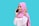 A smiling person wearing a pink hijab and white shirt holds a smartphone to their ear against a solid turquoise background. The individual appears to be engaged in a phone conversation, with a cheerful expression and an animated pose.