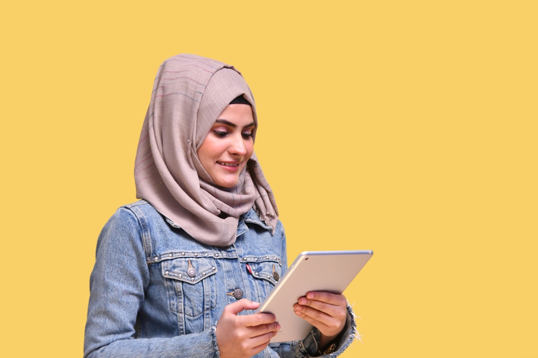 a person wearing a headscarf and holding a tablet, Download Mega Bundle of 5,000+ awesome stock photos with commercial license With 16 categories | Perfect for websites, ads and marketing campaigns in South Asian countries.</p>
<p style="text-align: left; margin-bottom: 1em;"></p>
<p style="text-align: left; margin-bottom: 1em;">Get access at 50% discount on https://fotos.pk/
