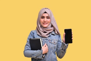 a person holding a phone and a tablet