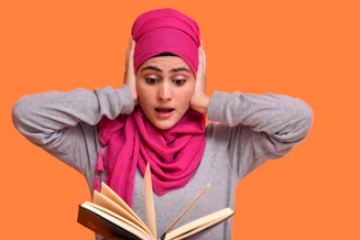 a person wearing a pink head scarf