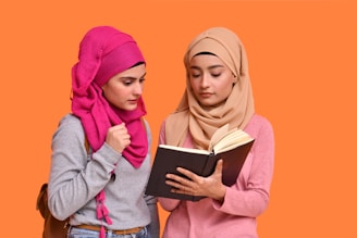 a couple of women looking at a tablet