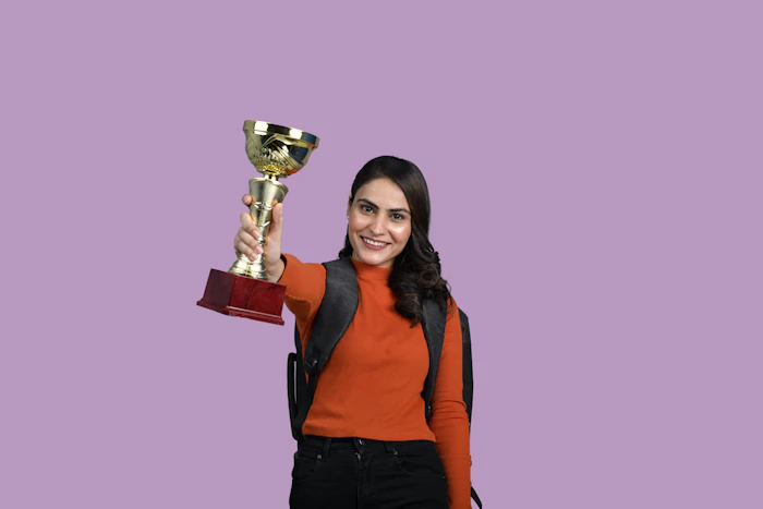 Student holding a sports achievement trophy representing college excellence
