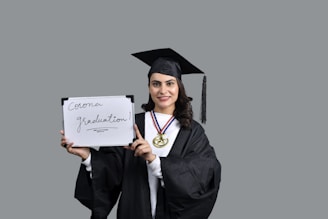 a person holding a diploma and a diploma