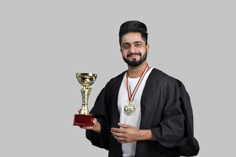 a man holding a trophy