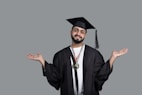 a man wearing a graduation cap and gown