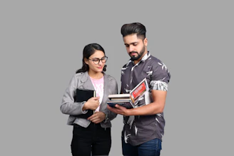 a man and a woman looking at a book