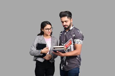 a man and a woman looking at a book