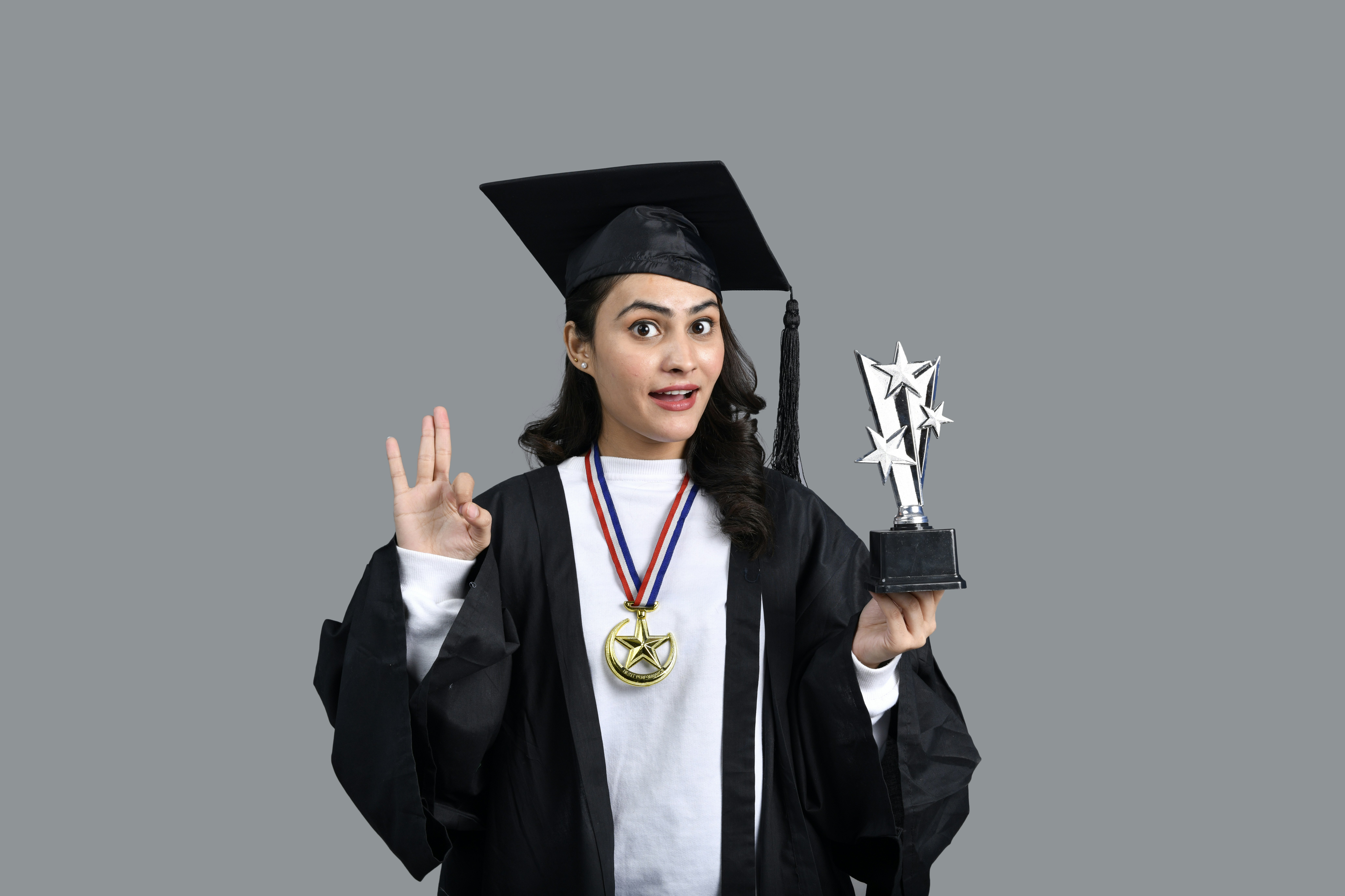 a person wearing a graduation cap and gown holding a diploma