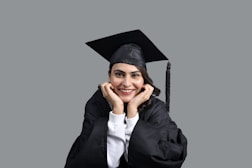 a person wearing a graduation cap and gown