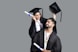 a man and woman wearing graduation gowns and caps