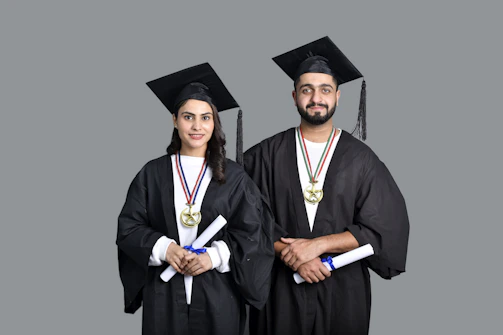 a man and woman wearing graduation gowns and caps