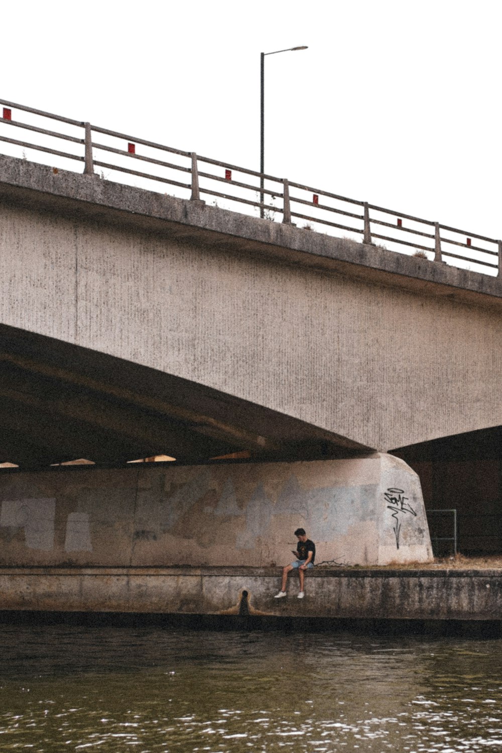 a person sitting on a concrete ledge