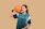 Happy woman trying on a basketball jersey at Gulf Sports Co.