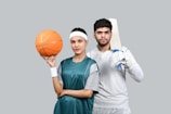 a man and a woman holding a basketball