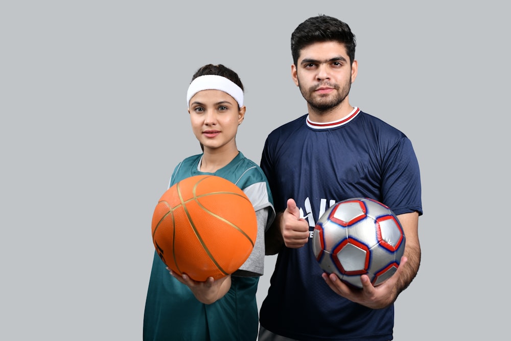 a man and a woman holding basketballs