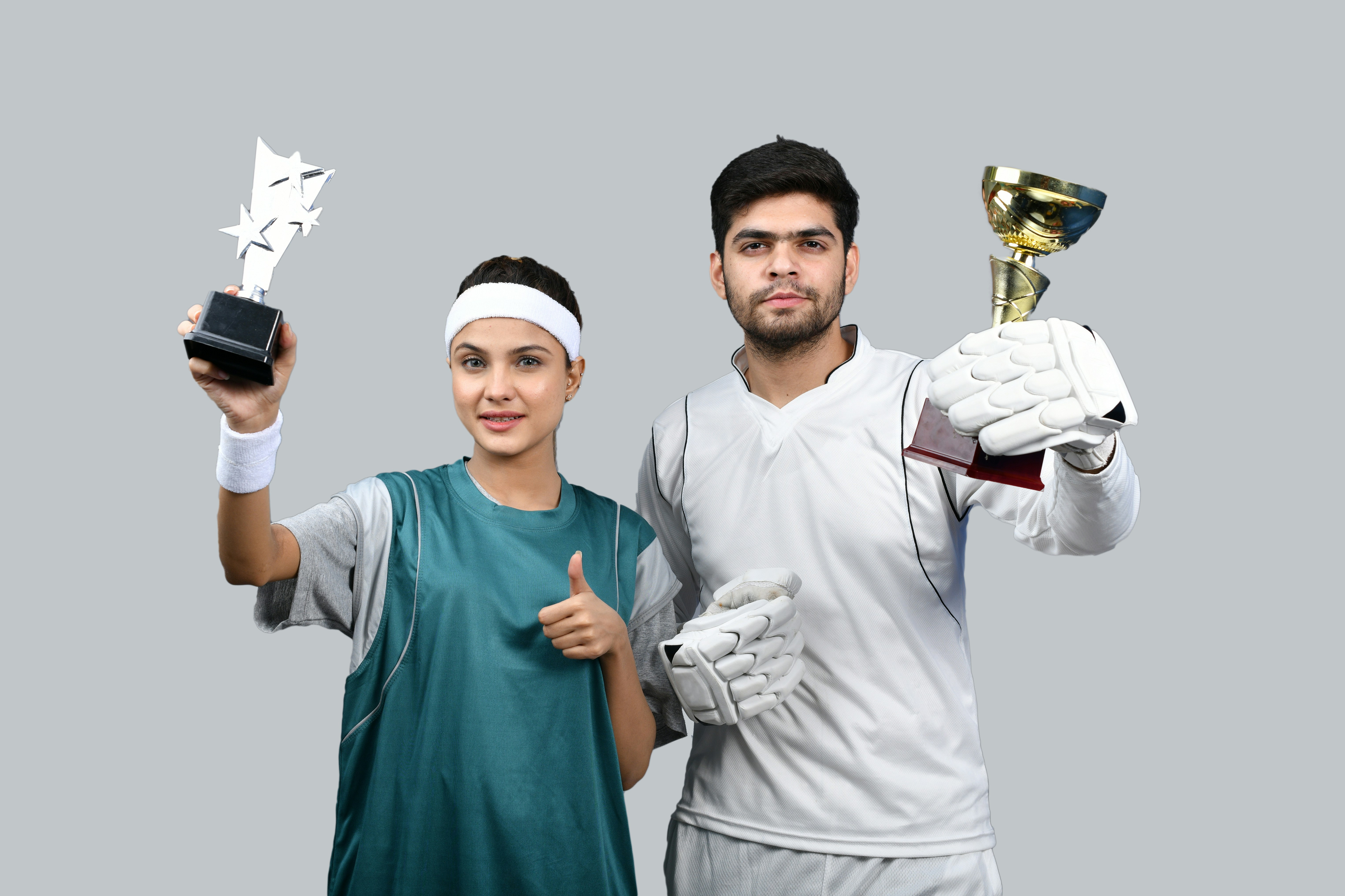 a man and woman holding up trophies