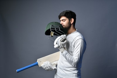 a man wearing a white coat and gloves holding a sword