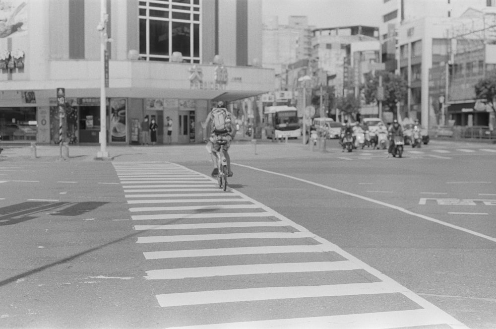 a person riding a bicycle across a crosswalk