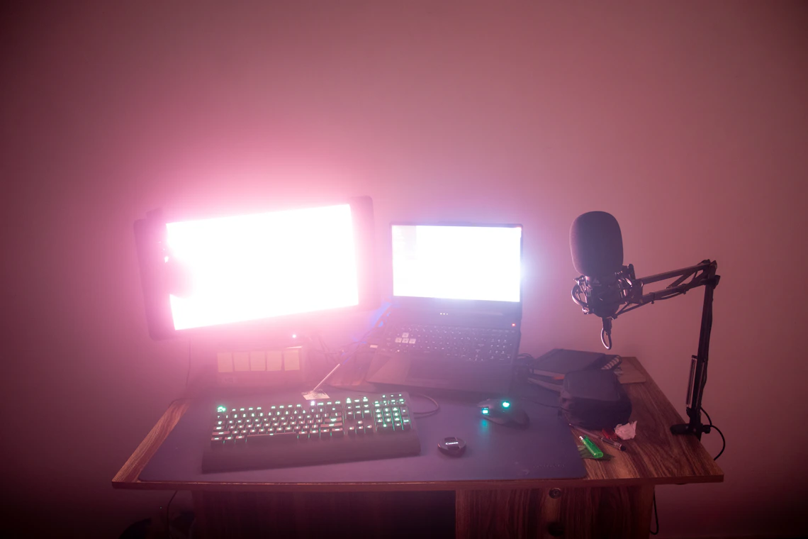 Real desktop streaming setup with dual displays, keyboard and microphone