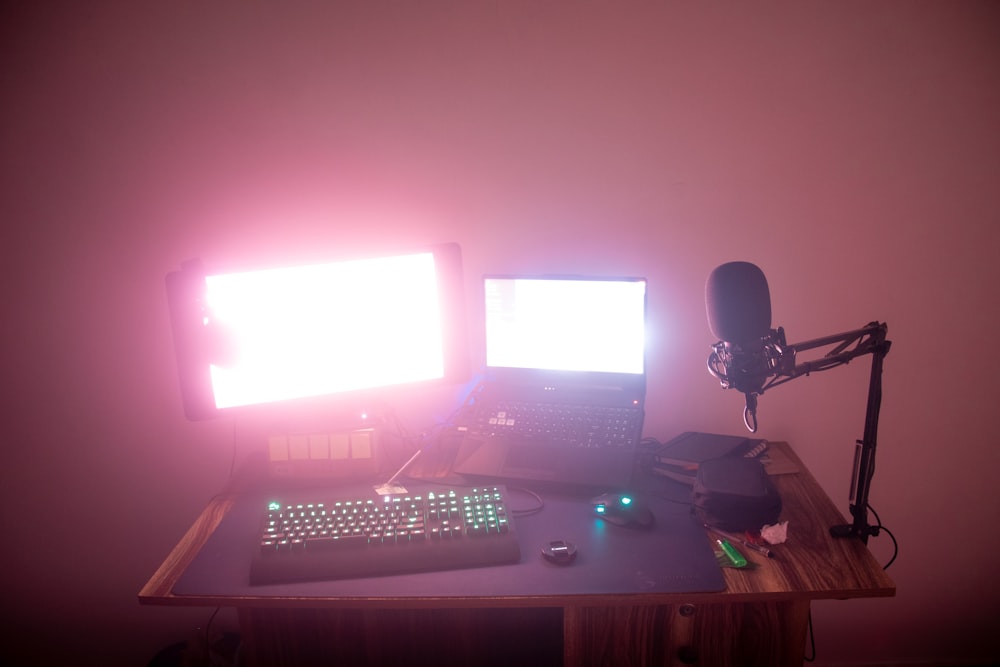 a desk with a computer and a microphone on it