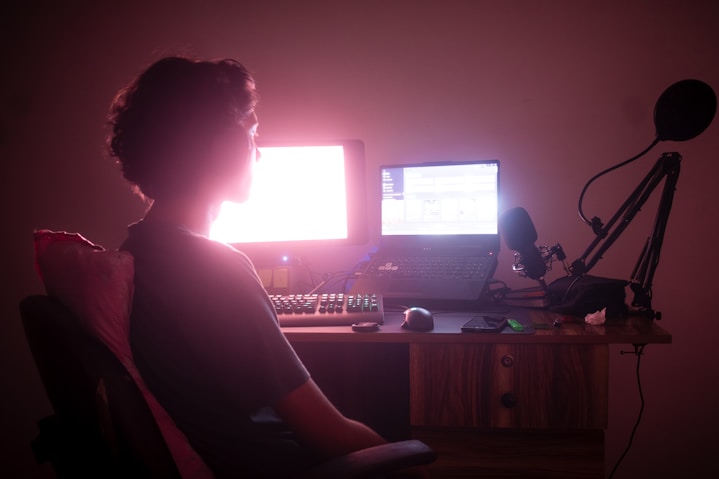 a person sitting in front of a computer