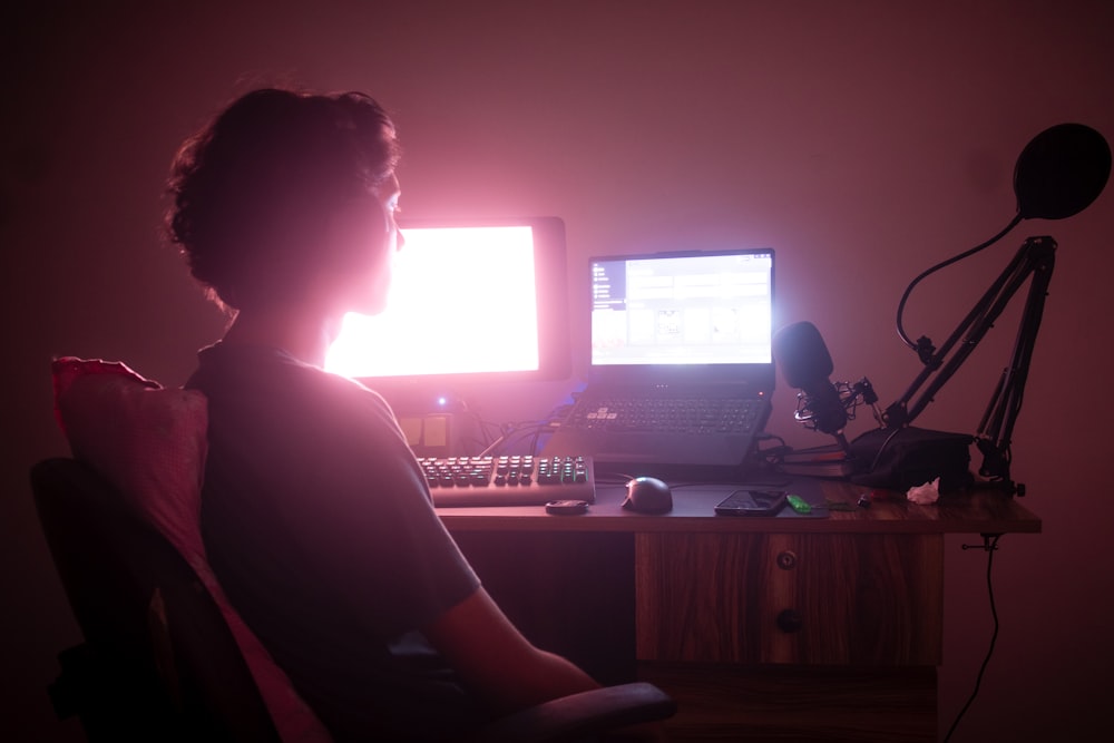 a person sitting in front of a computer