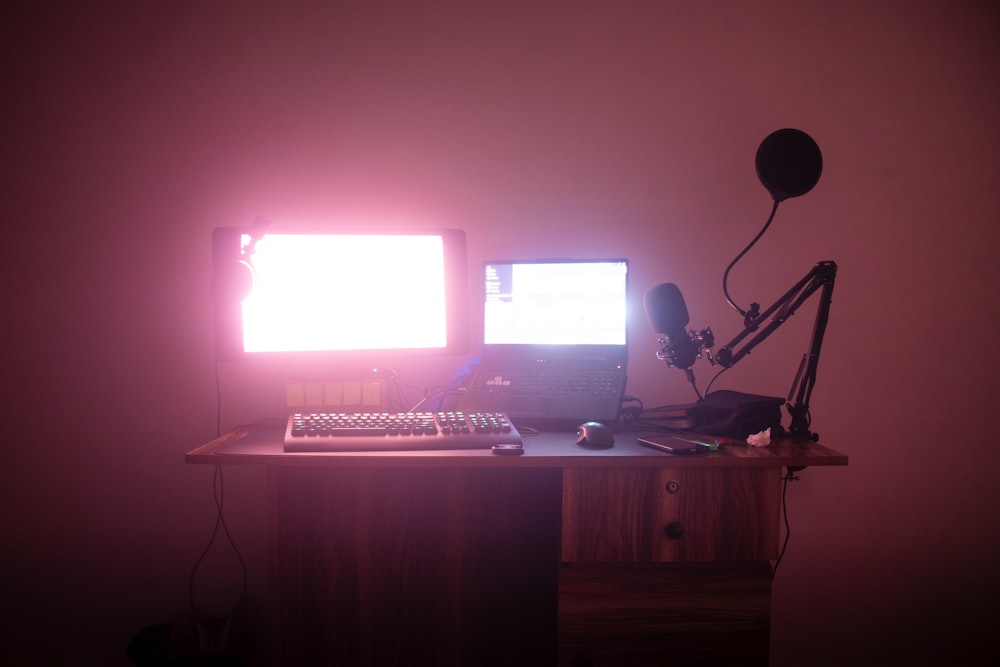 a desk with a computer and a microphone on it