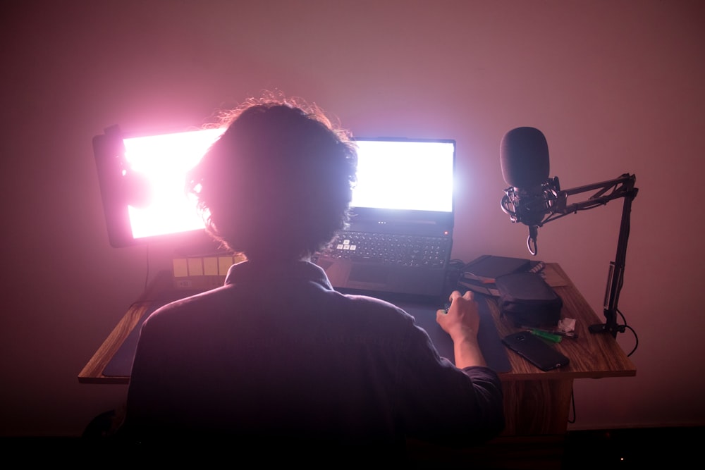 a person sitting in front of a computer