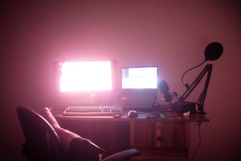 a desk with a computer and a camera on it