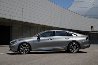 a silver car parked outside a building